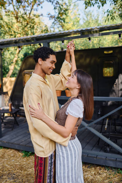 istock A multicultural couple happily relaxes by their camping van in a serene forest 2167516681