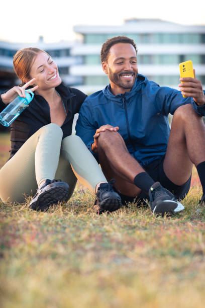 istock Young couple taking a selfie with their smartphone ready to exercise.Vertical 2167516806