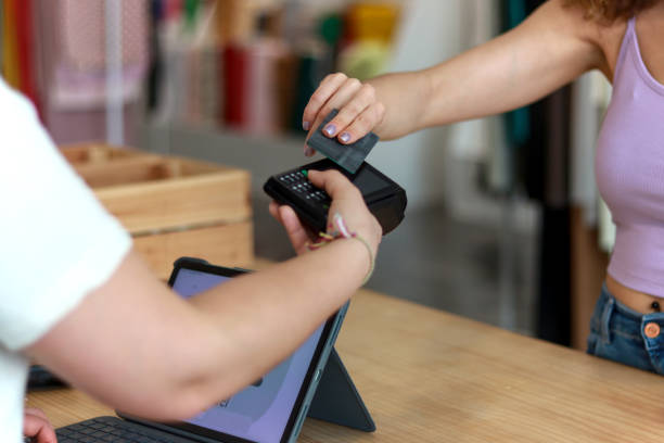 istock Customer paying with a credit card at a retail store using a wireless POS terminal 2167518184