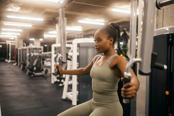 istock A fit black sportswoman is practicing chest on exercise machine in a gym. 2167518853