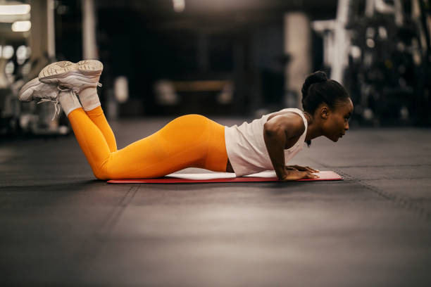 istock A muscular black sportswoman in shape practicing pushups at gym. 2167518923