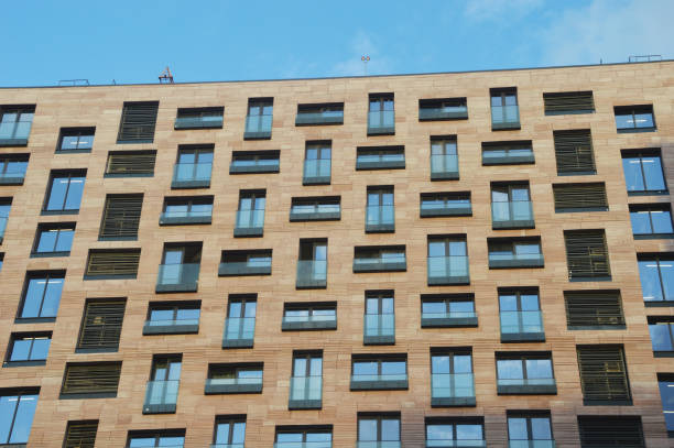 Facade of a multi-story brick residential building. Modern urban architecture.