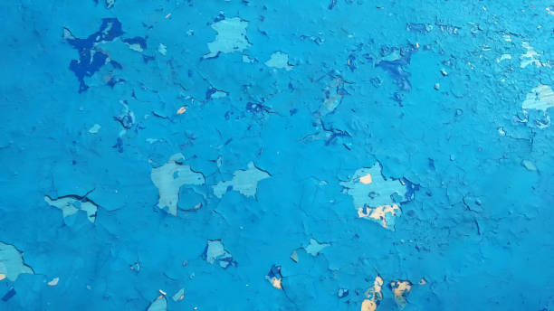 Blue cracked paint, grunge abstract wall background.