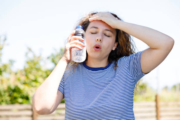 istock Young woman having hot flash and sweating in a warm summer day 2167520972