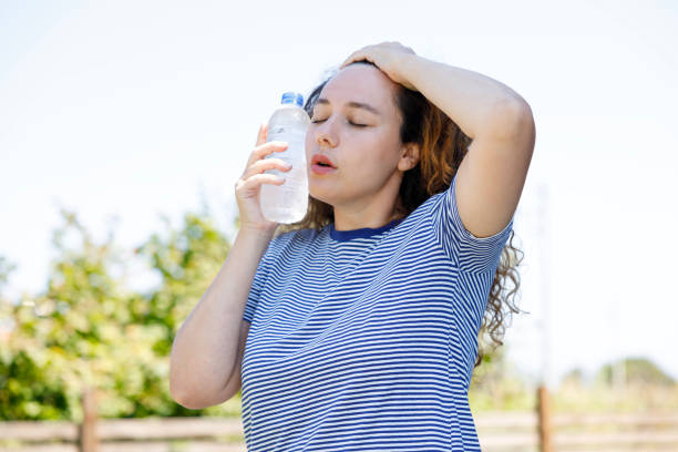 istock Young woman having hot flash and sweating in a warm summer day 2167521025