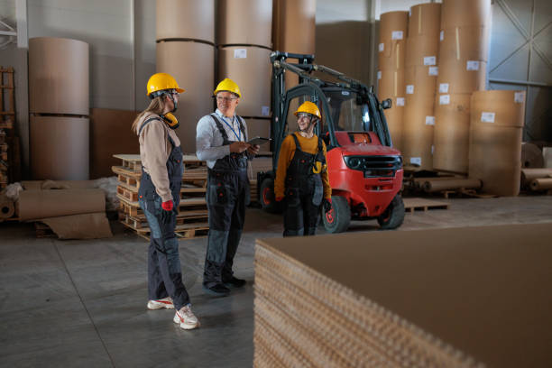 istock Paper factory workers inspecting products in a warehouse 2167521265