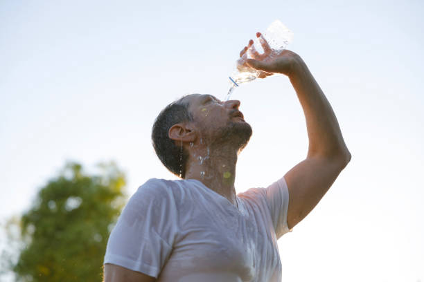 istock Young man cools down with cold water during the summer heat 2167521419