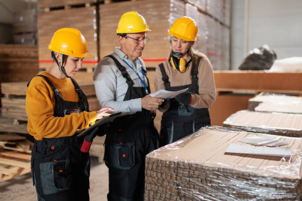 istock Paper factory workers inspecting products in a warehouse 2167521457
