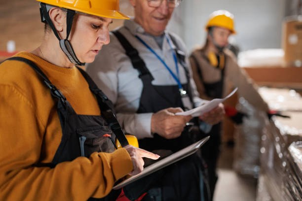 istock Paper factory workers inspecting products in a warehouse 2167521586