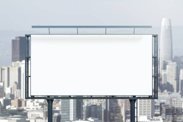 istock Blank white billboard on cityscape background at daytime, front view. Mock up, advertising concept 2167526725