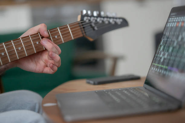 istock Man learning to play guitar with laptop 2167526973