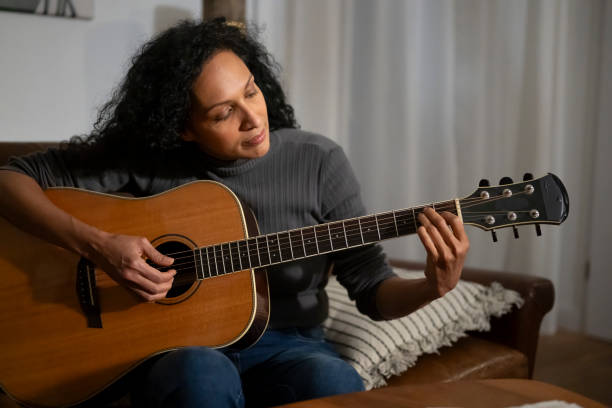 istock Mature woman playing guitar 2167527536