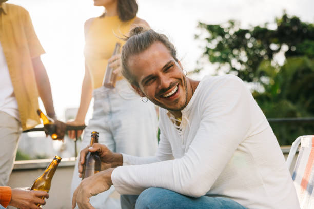 istock Happy man enjoying drinks outside with friends on the weekend 2167529225