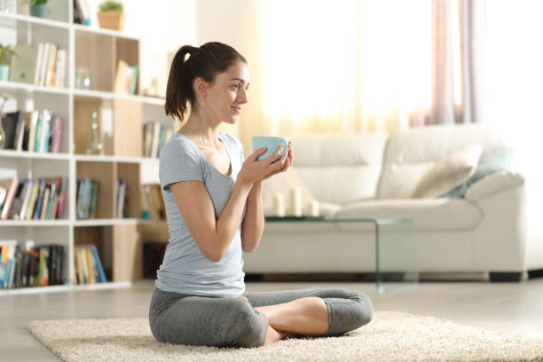 istock Happy yogi drinking tea before doing yoga exercise 2167530497