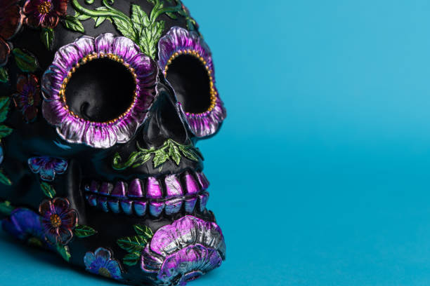 istock A black skull with metallic floral decorations, prominently displayed against a deep blue background 2167531069