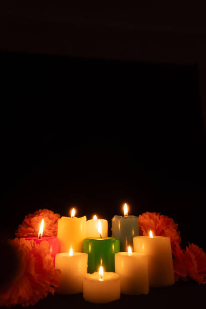 istock Lit candles surrounded by marigolds are arranged centrally, casting a gentle light in the darkness 2167531216