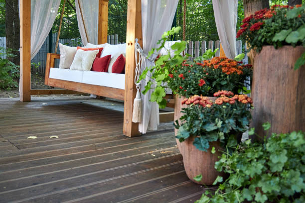 Wooden porch swing with mountain view in background.