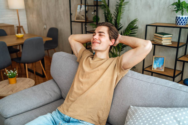 istock Satisfied young man relaxing at home 2167531861