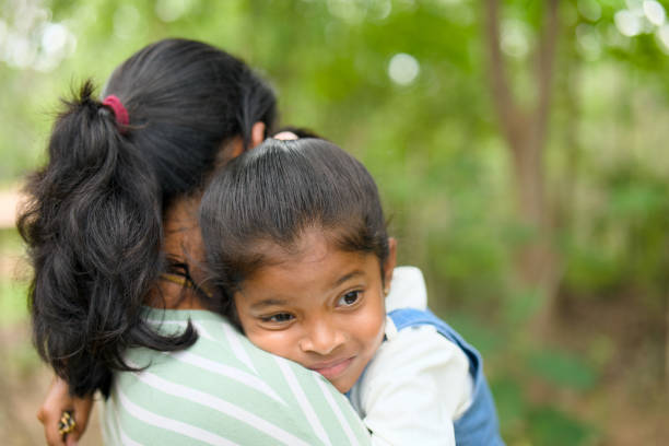 istock Mother Daughter Embrace in Nature 2167534082