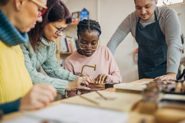 istock Group of artisans collaborating on a detailed project. 2167535174