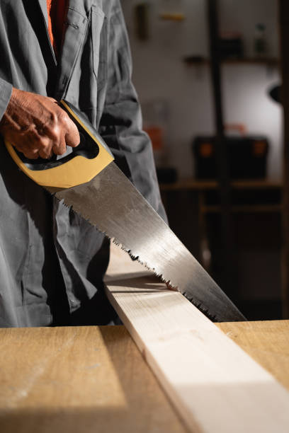 istock Male carpenter works in workshop with a metal saw 2167535187