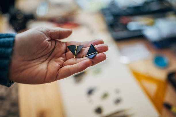 istock Hand holding geometric crafts in a creative workspace 2167535898