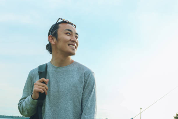 istock Portrait Of Handsome Confident Young Man With Blue Sky 2167537617