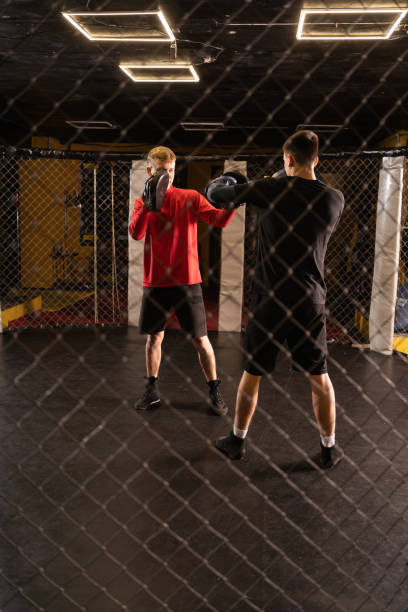 istock Two young professional boxer boxing in gym cage 2167539822
