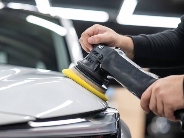 istock Process of polishing white car hood surface using orbital polishing machine. 2167540926