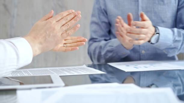 istock Unrecognizable business people clapping over glass table after contract signing in office. Agreement and handshake themes 2167544444