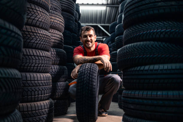 istock Working in warehouse arranging new car tires. 2167544471