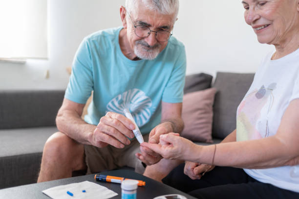 istock Husband Helping Diabetic Wife Check Blood Sugar Level Using Blood Glucose Meter At Home 2167545943