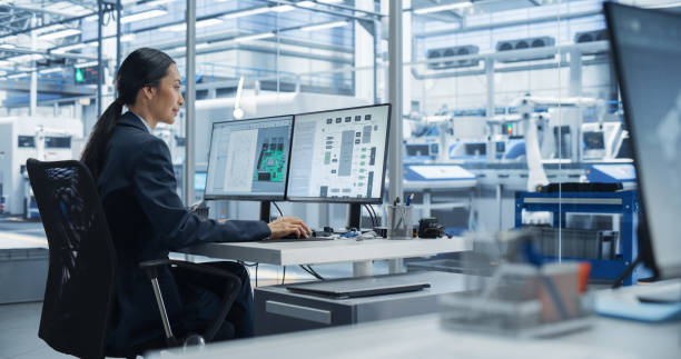istock Asian Industrial Engineer Doing Creative Work on Computer in Office. Intelligent Female Creating an Innovative Motherboard with Powerful Microchips for Artificial Intelligence Systems 2167548309