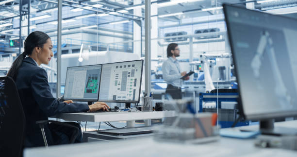 istock Asian Industrial Engineer Doing Creative Work on a Computer in Office. Intelligent Female Creating an Innovative Motherboard with Powerful Microchips for Artificial Intelligence Systems 2167548368