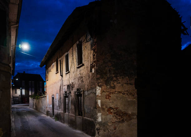 empty street by night with abandoned home
