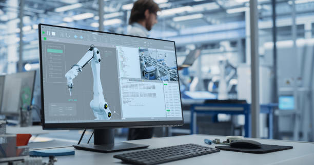 istock Modern Industrial Manufacture with Desktop Computer with Automation Software for Robotic Arm. Scientific Lab, Engineering Research Center with High-Tech Equipment, Technology for Robot Development 2167549183