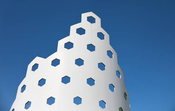 Large facade elements in honeycomb form on a high-rise building with glass front