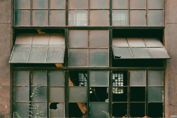 Broken Glass Window With Rusted Metal Grate
