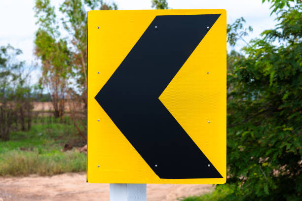Keep left, or curve left ahead of the warning signpost on the road in the countryside