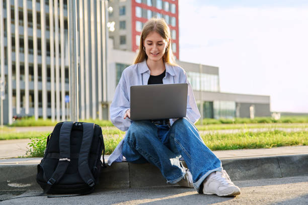 istock Young female college student using laptop computer outdoor 2167551603