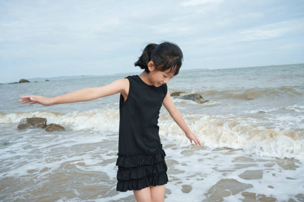 Asian girl playing at the beach