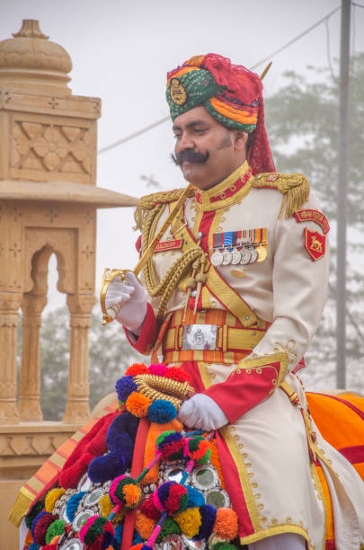 Jaisalmer, Rajasthan, India. February 20, 2016. Jaisalmer Desert Festival. Camel and indian people wearing traditional Rajasthani dress. Attend a cultural procession for the Desert festival.