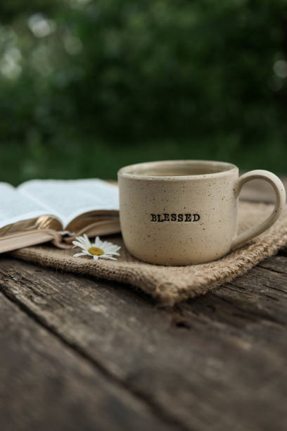 istock Cup with text BLESSED and open Bible in the garden, good morning 2167554764