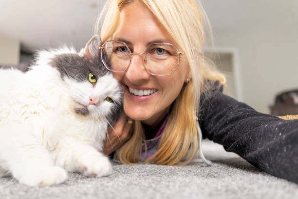 istock Woman Taking Selfie With Affectionate Cat on Floor 2167555300