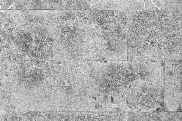 Smooth gray block stone wall with unique natural textures and patterns. Abstract architecture background