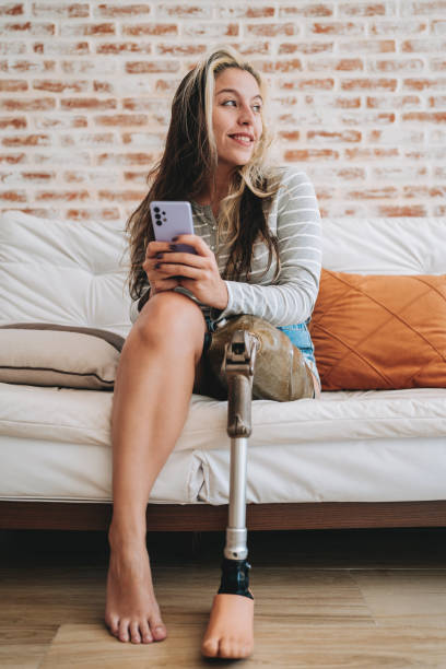 istock woman with amputated leg using smartphone 2167556650