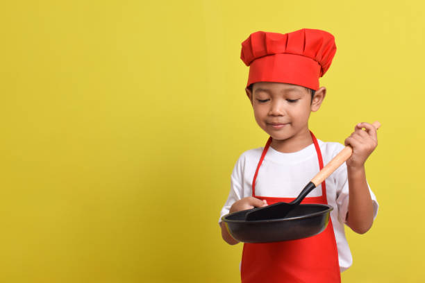 istock Cute little chef with frying pan and spatula. 2167556821