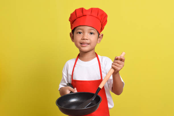istock Cute little chef holding frying pan and spatula 2167556837