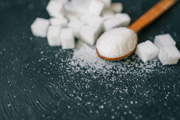 istock White crystalline sugar cubes on a wooden spoon 2167558514