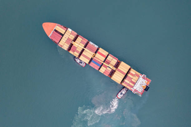 istock Aerial view of Cargo Container Ship approaching port with tugboat. 2167559191